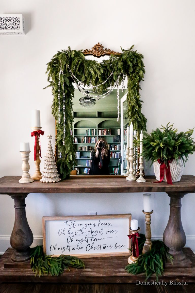 Simple Christmas Entryway Decor with a traditional red-and-green color scheme, garlands, and evergreen stems.