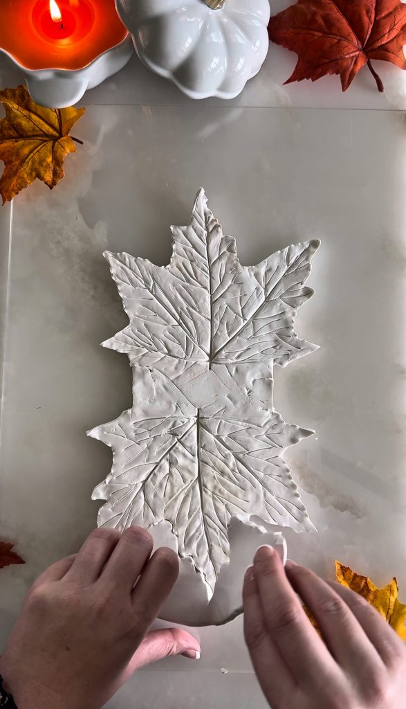 This DIY Clay Leaf Napkin Holder is a fun fall craft that makes a great gift and beautiful autumn decor for your kitchen.