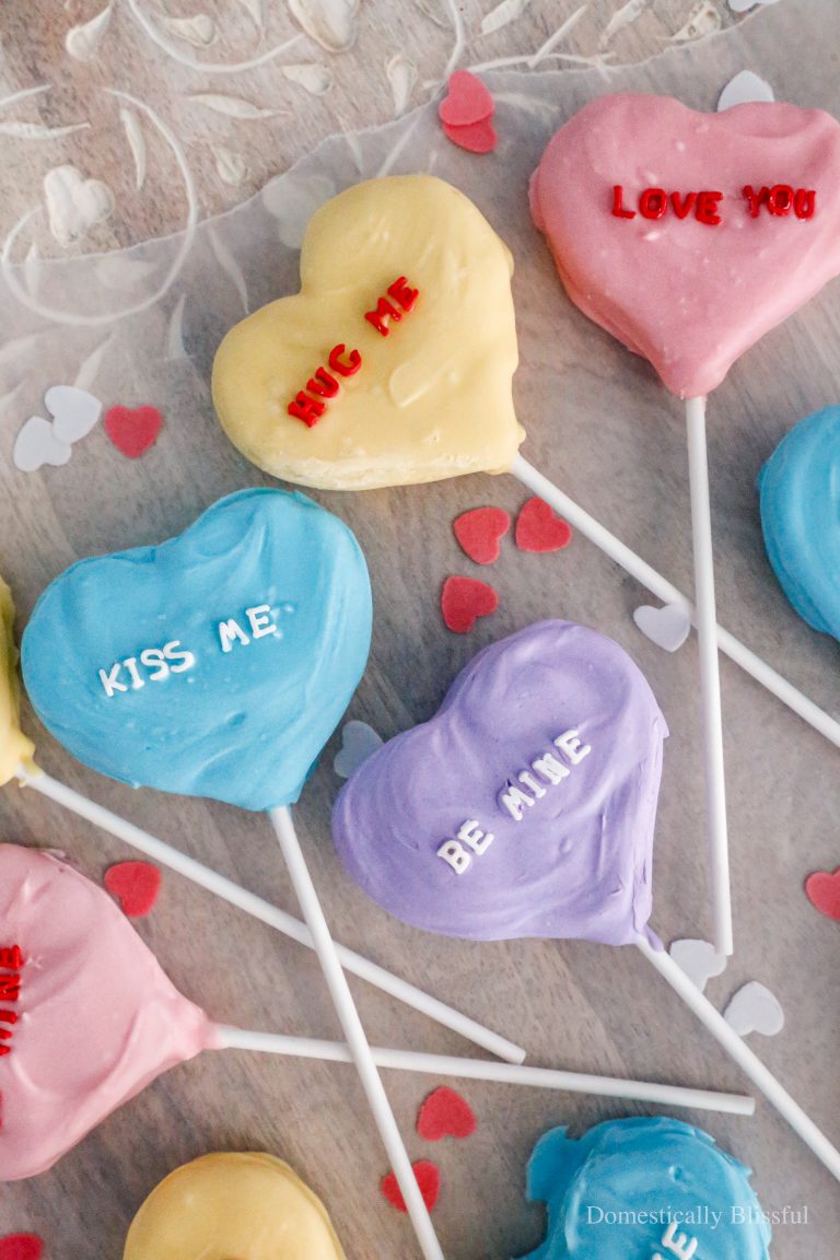 These Conversation Heart Cake Pops are a fun way to repurpose a cake into colorful heart-shaped cake pops with a sweet message on top for Valentine's Day or a Galentine's party.
