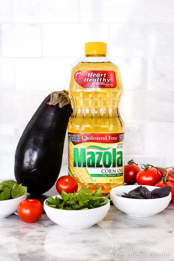 This Grilled Eggplant Salad is marinated, grilled, and topped with whipped ricotta, pesto, quartered tomatoes, and fresh herbs.