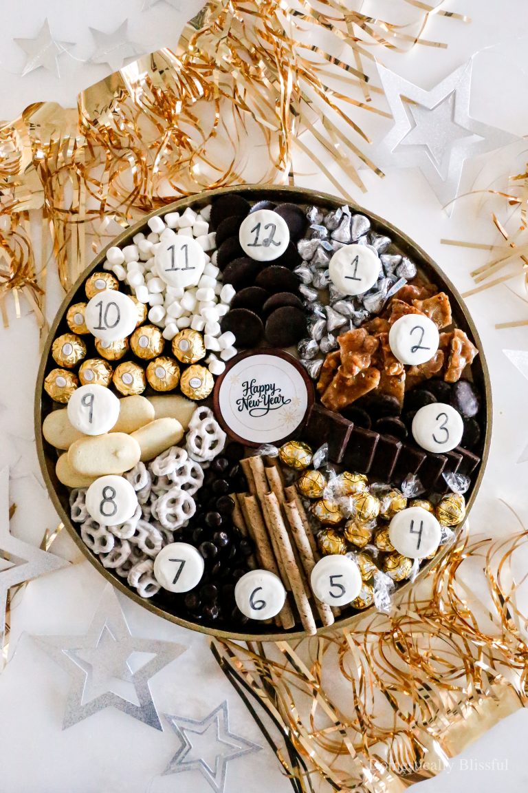 This New Year's Eve Clock Dessert Charcuterie Board has 12 desserts and is topped with numbered cookies written with an edible marker.