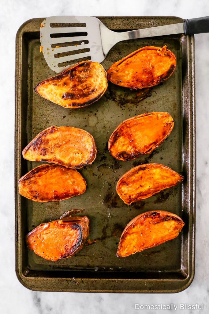 These Loaded Black Bean Taco Sweet Potatoes are covered in seasoned black beans and corn and topped with cheese, sour cream, salsa, guacamole, cilantro, and a squeeze of lime.