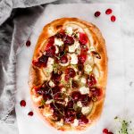 This Cranberry Pear Flatbread is topped with goat cheese, fresh pear, cranberry sauce, and pecans, making it a delicious Thanksgiving leftover recipe.