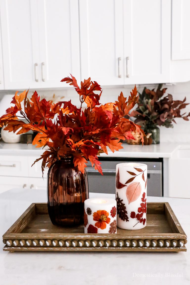 How to create DIY Pressed Leaves and Flower Fall Candles with pressed leaves and fall flowers on pillar candles with my flameless candle hack to create decorative flameless candles for fun fall decor.