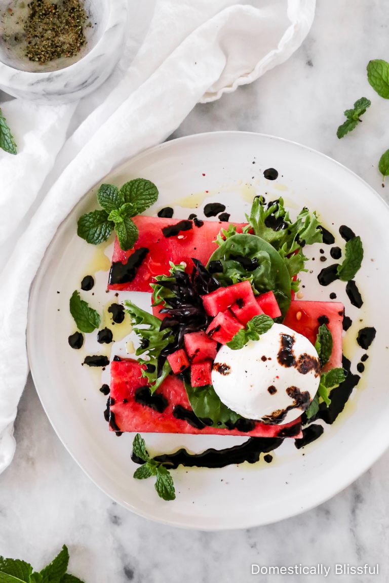 A simple Watermelon Burrata Salad with mixed greens, fresh mint, extra virgin olive oil, and balsamic.