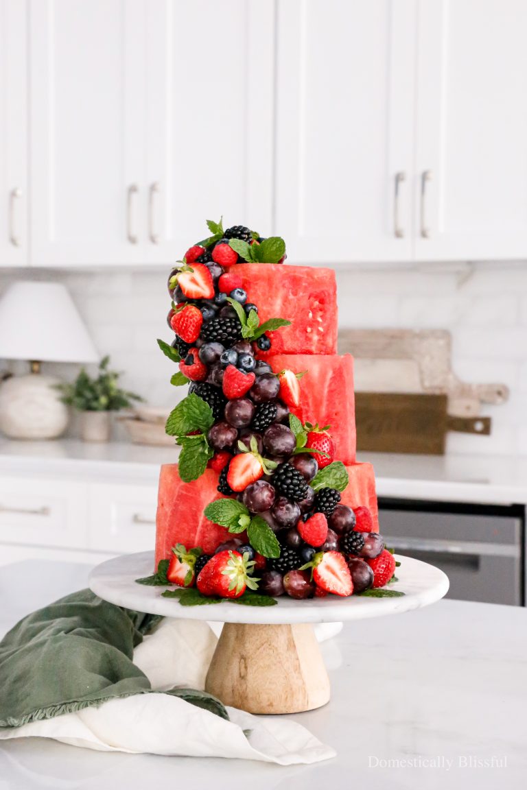 A Watermelon Cake made of only watermelon and decorated with lots of fresh fruit.
