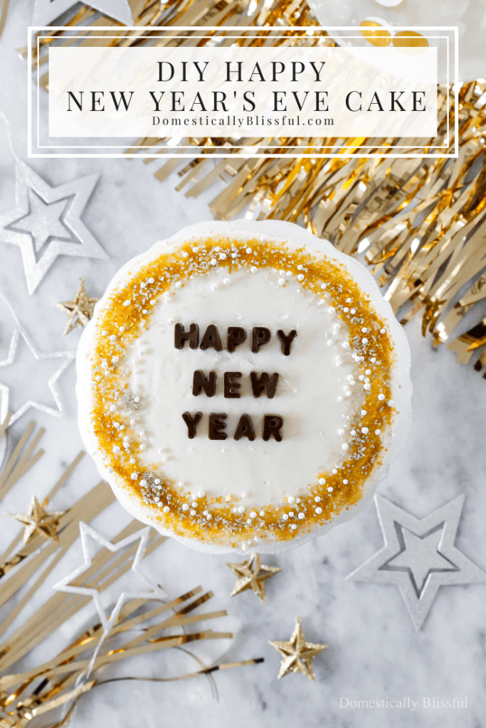 A quick and easy DIY Happy New Year's Eve Cake using a store-bought cake and redecorating it with gold, silver, and white sprinkles and chocolate letters.