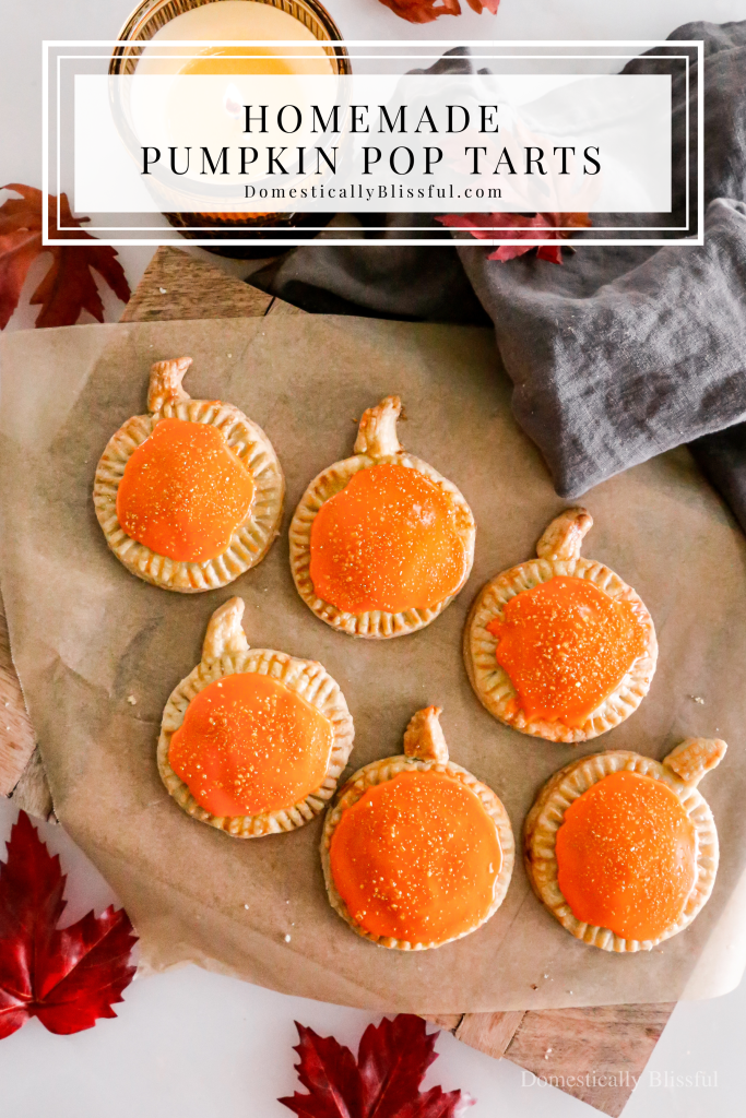These Homemade Pumpkin Pop Tarts are made with pie crust and have a sweet pumpkin filling topped with orange icing and sprinkles, making them perfect for a fall party or Thanksgiving brunch.