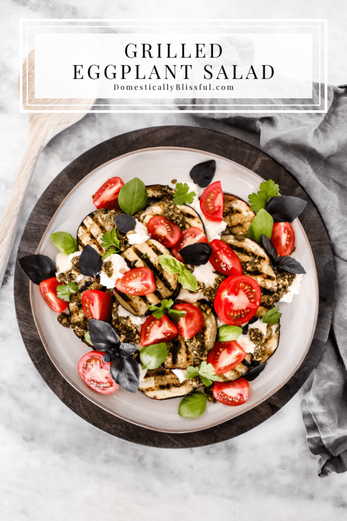 This Grilled Eggplant Salad is marinated, grilled, and topped with whipped ricotta, pesto, quartered tomatoes, and fresh herbs.