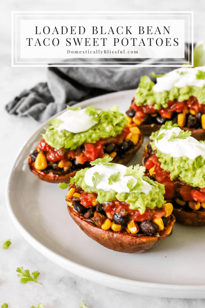 These Loaded Black Bean Taco Sweet Potatoes are covered in seasoned black beans and corn and topped with cheese, sour cream, salsa, guacamole, cilantro, and a squeeze of lime.