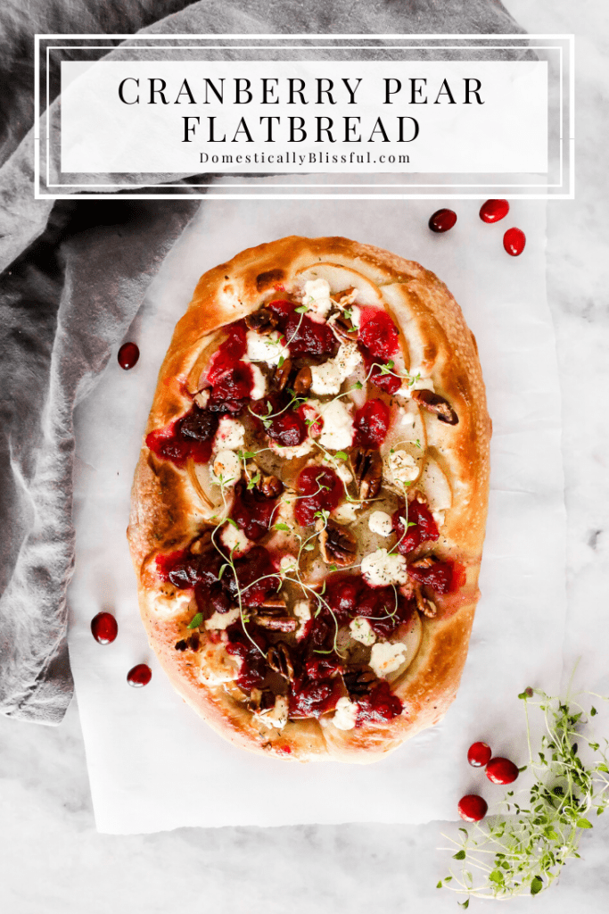 This Cranberry Pear Flatbread is topped with goat cheese, fresh pear, cranberry sauce, and pecans, making it a delicious Christmas appetizer or Thanksgiving leftover recipe.