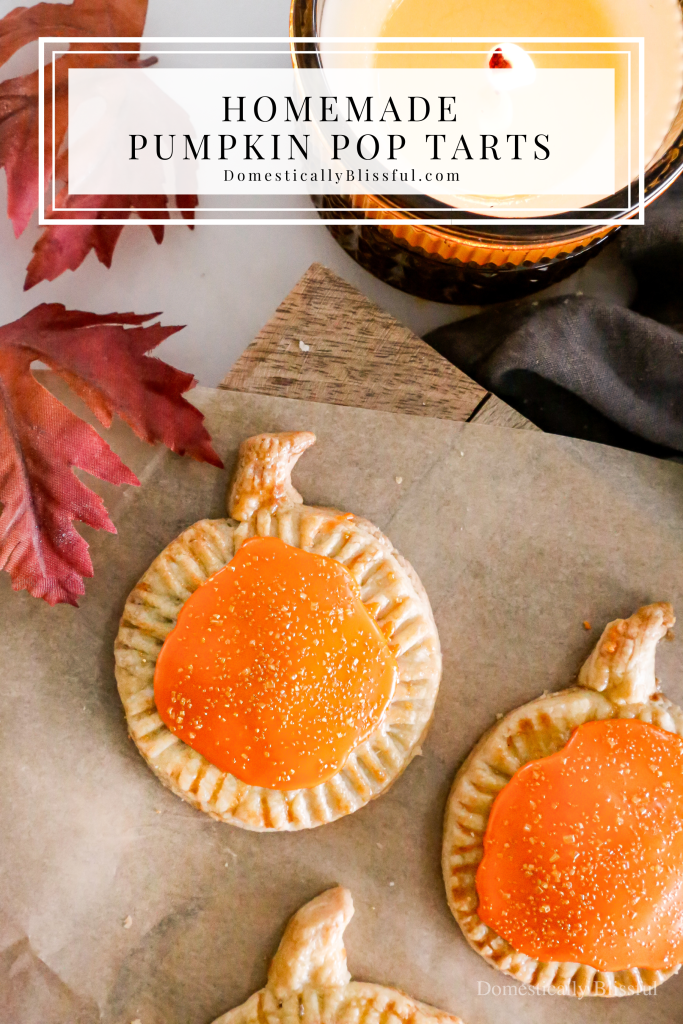 These Homemade Pumpkin Pop Tarts are made with pie crust and have a sweet pumpkin filling topped with orange icing and sprinkles, making them perfect for a fall party or Thanksgiving brunch.